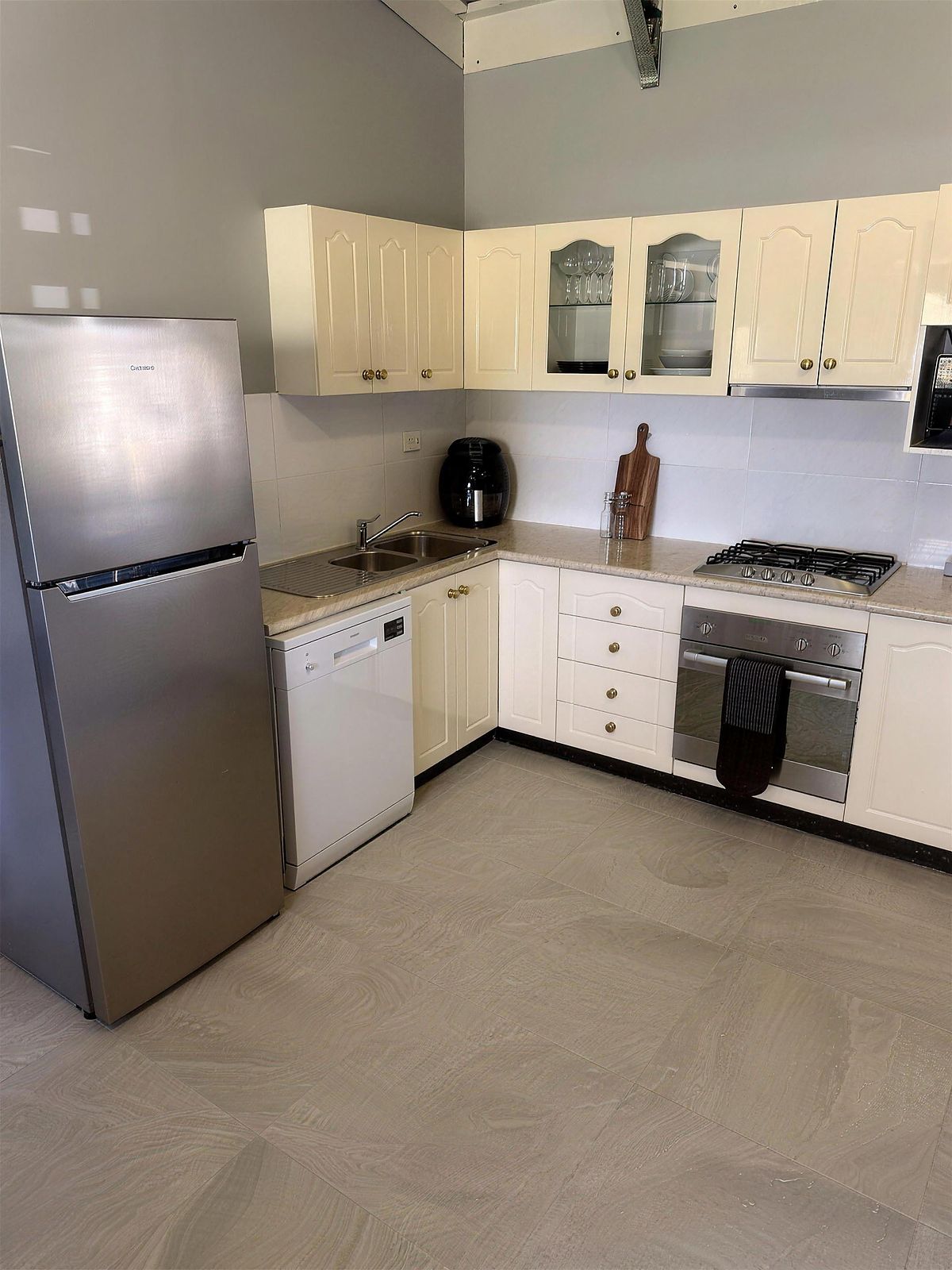 Kitchen with fridge and cooktop
