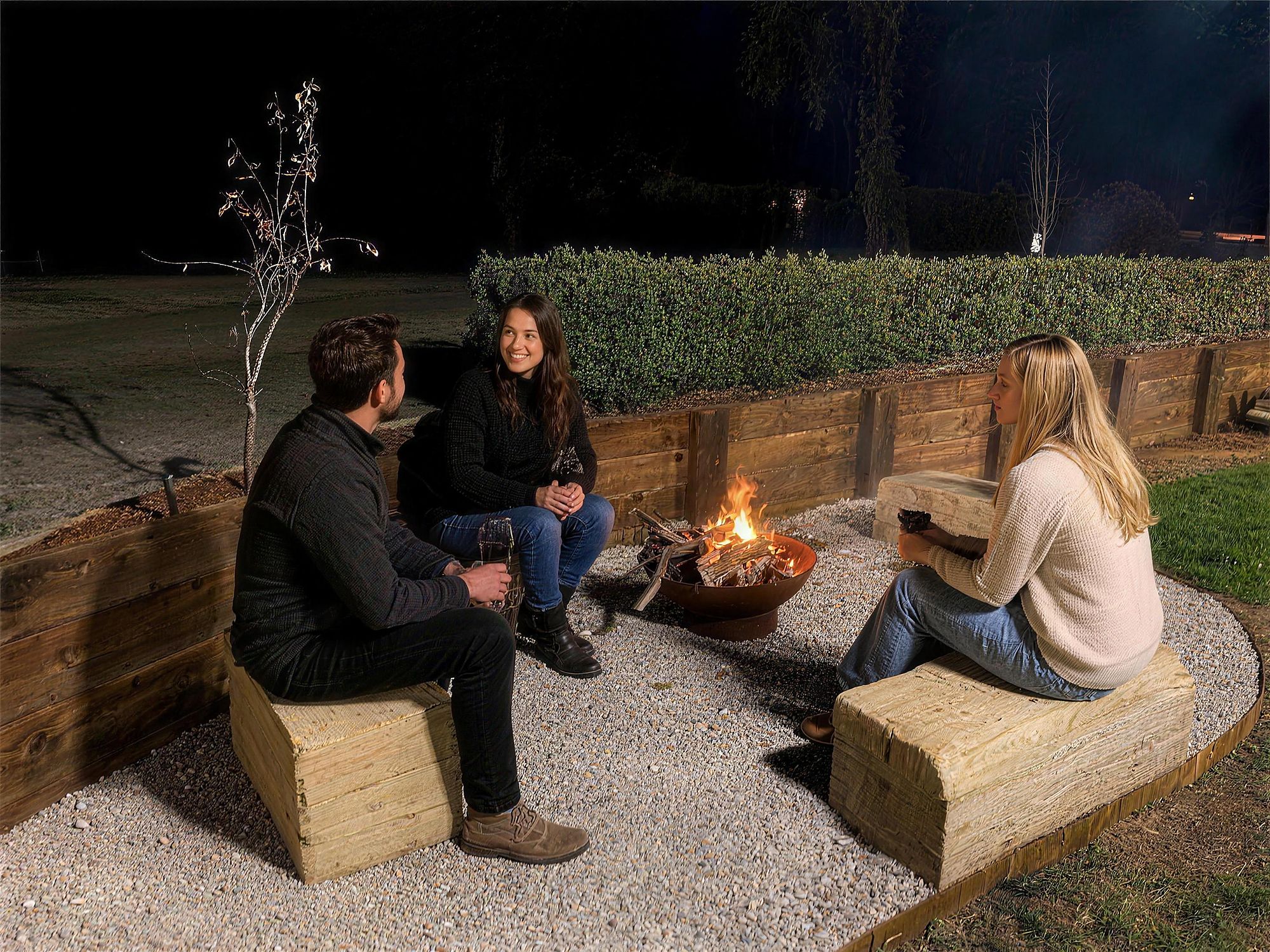 Guests around the fire pit at night